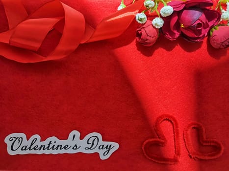 Valentine's Day concept celebration, congratulation. Red greeting Card with flower, Satin ribbon for Background, texture, place for text, copy space