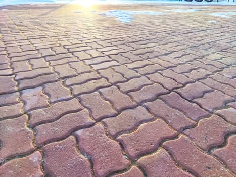 Red tiles and snow on the ground. Background, texture, pattern, copy space