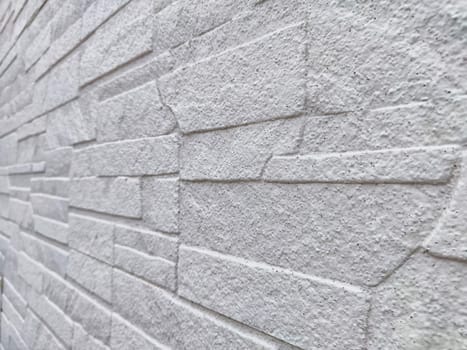 Uneven stones or bricks as background and texture. Background, texture, pattern, frame, copy space. Close-up view of a wall with uneven stone bricks