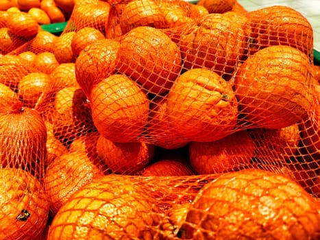 A Multitude of Fresh Oranges on Display at a Market Stall. Piles of vibrant oranges creating colorful texture in a market