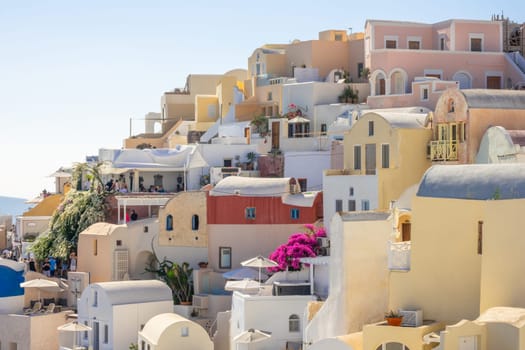 Greece. Sunny summer day in the Santorini caldera. White buildings of terraced hotels on Oia