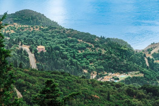 Forest houses with red tile rooftops around green plantation in Lefkada Ionian Island Greece.