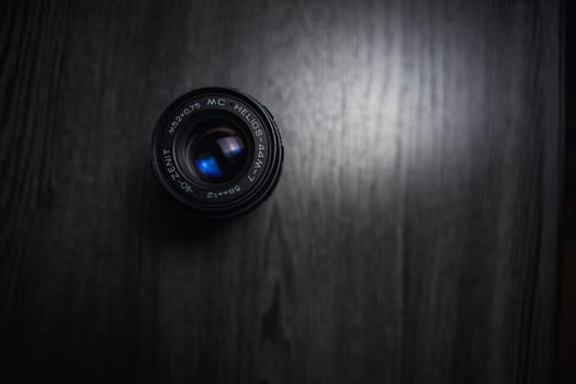 Classic Helios 44-7 lens on a wooden table . High quality photo