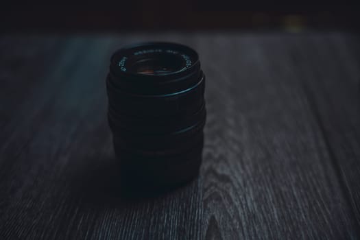 Classic Helios 44-7 lens on a wooden table . High quality photo