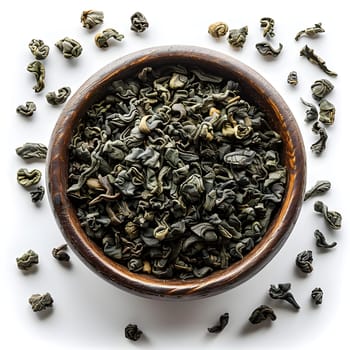 A wooden bowl filled with organic green tea leaves, a superfood ingredient, placed on a white surface for brewing a healthy drink