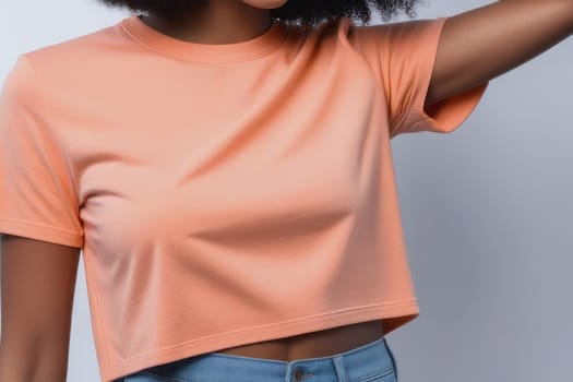 Woman in peach fuzz colored tshirt, can be used for design, mock up. The trending color of 2024