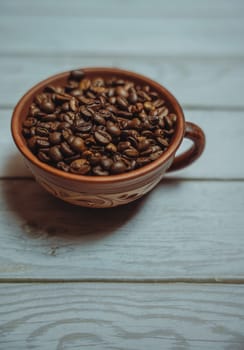 Coffee beans in a clay mug. High quality photo