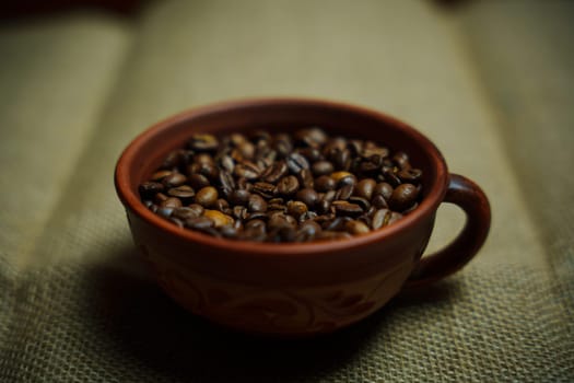 Coffee beans in a clay mug. High quality photo