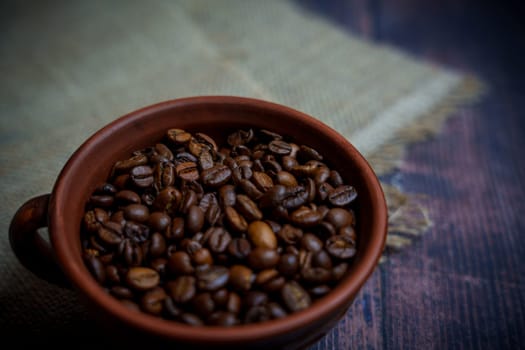 Coffee beans in a clay mug. High quality photo