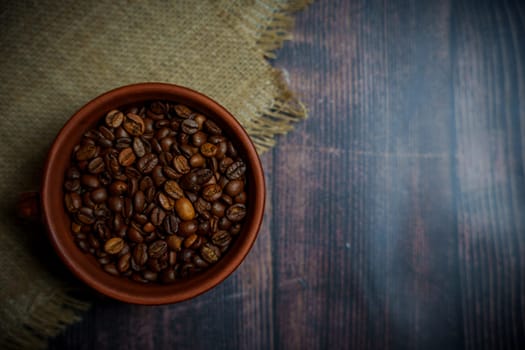 Coffee beans in a clay mug. High quality photo