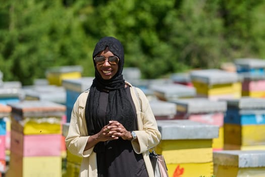 African American Muslim woman in hijab explores natural bee farms for honey production, blending tradition with sustainability in the serene countryside.