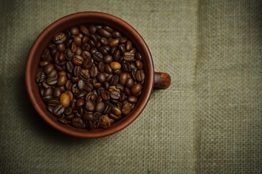 Coffee beans in a clay mug. High quality photo