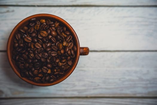 Coffee beans in a clay mug. High quality photo