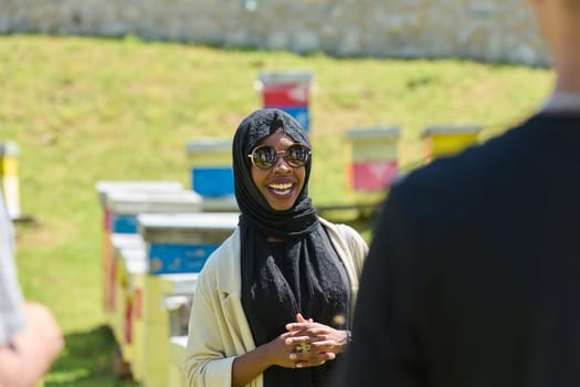 A diverse group of young friends and entrepreneurs explore small honey production businesses in the natural setting of the countryside