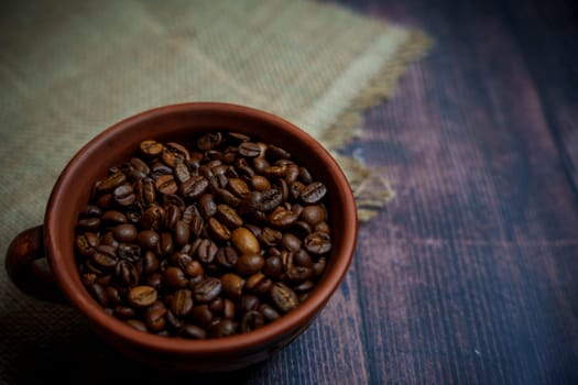 Coffee beans in a clay mug. High quality photo