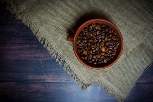 Coffee beans in a clay mug. High quality photo