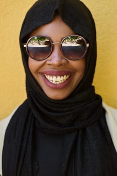 A close-up portrait captures the engagement of a Middle Eastern teenage Muslim girl in her digital world, as she uses a smartphone with focused attention