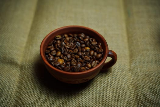 Coffee beans in a clay mug. High quality photo