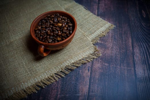 Coffee beans in a clay mug. High quality photo