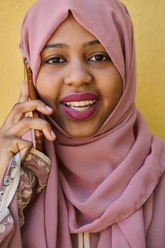 A close-up portrait captures the engagement of a Middle Eastern teenage Muslim girl in her digital world, as she uses a smartphone with focused attention