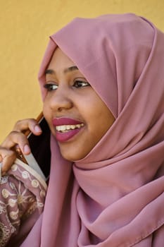 A close-up portrait captures the engagement of a Middle Eastern teenage Muslim girl in her digital world, as she uses a smartphone with focused attention