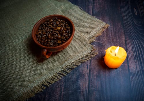 Coffee beans in a clay mug. High quality photo