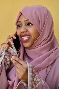 A close-up portrait captures the engagement of a Middle Eastern teenage Muslim girl in her digital world, as she uses a smartphone with focused attention