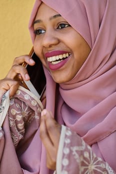 A close-up portrait captures the engagement of a Middle Eastern teenage Muslim girl in her digital world, as she uses a smartphone with focused attention