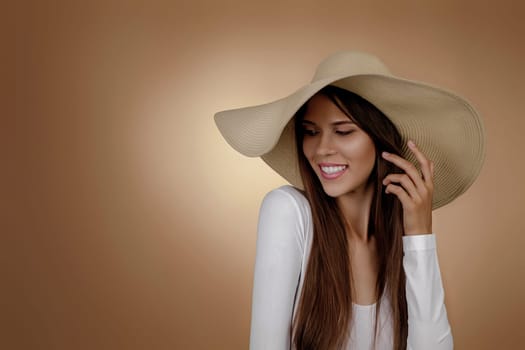 Portrait of young smiling woman in fashionable summer hat. copy space