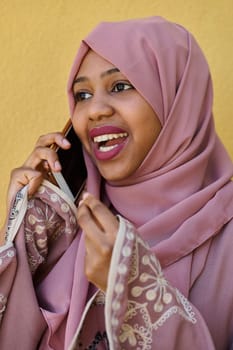 A close-up portrait captures the engagement of a Middle Eastern teenage Muslim girl in her digital world, as she uses a smartphone with focused attention