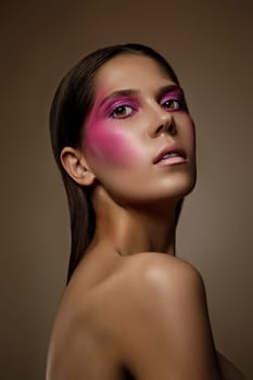 Fashion art skin woman face portrait, closeup. Glamour shiny professional makeup girl with trendy pink make-up