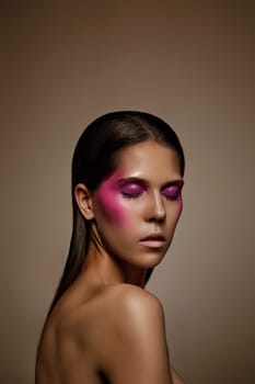 Fashion art skin woman face portrait, closeup. Glamour shiny professional makeup girl with trendy pink make-up