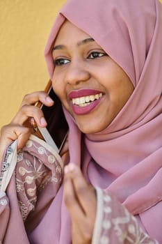 A close-up portrait captures the engagement of a Middle Eastern teenage Muslim girl in her digital world, as she uses a smartphone with focused attention