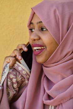 A close-up portrait captures the engagement of a Middle Eastern teenage Muslim girl in her digital world, as she uses a smartphone with focused attention