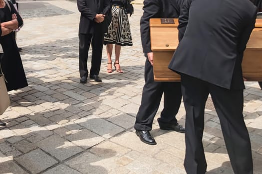 Funeral service loading the coffin into the hearse