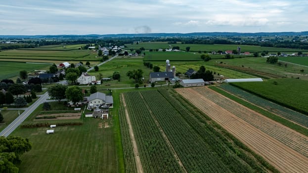 An Aerial View of Rural Farmland with Houses and Silos