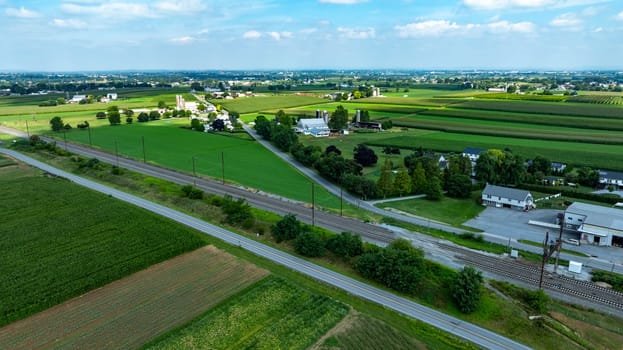 An Aerial View of Rural Community with Farmland, Roads, and Railway