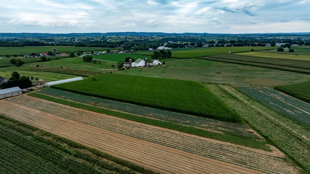 An Aerial View of Farmland with Barns and Silos in Rural Countryside