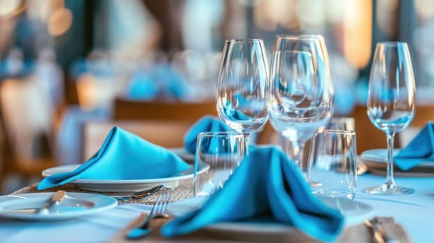 Elegant table setting with blue napkins and wine glasses for a sophisticated dinner event or celebration