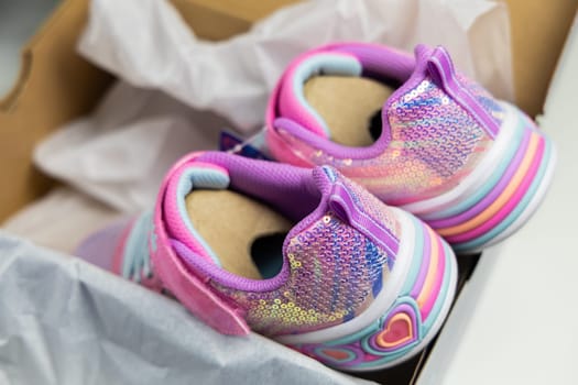 Children's sports shoes. New fashion sneakers for children in box. High quality photo