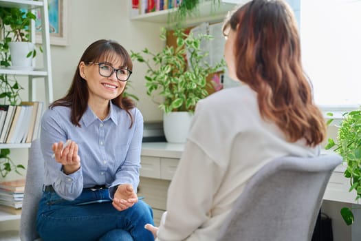 Female psychologist psychotherapist therapist counselor social worker talking working with young woman, meeting session therapy in office. Mental health, psychology psychotherapy counseling, youth