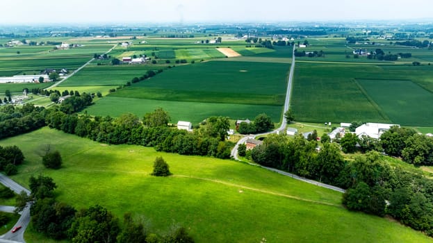 An Aerial View of Expansive Farmlands and Country Roads