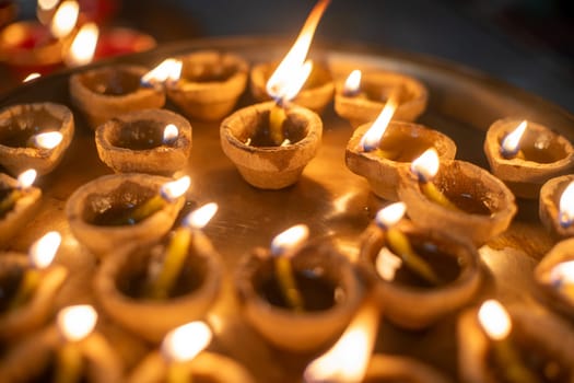 macro shot showing a circle of diya oil lamps showing the offerings and prayers to the hindu wealth goddess lakshmi in India