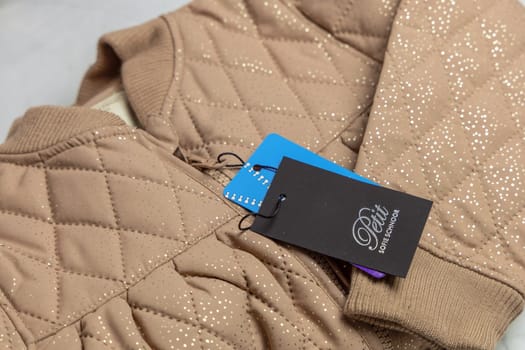 New Children's jacket with label. Pink clothes with glitter for girls. Denmark - November 15, 2023