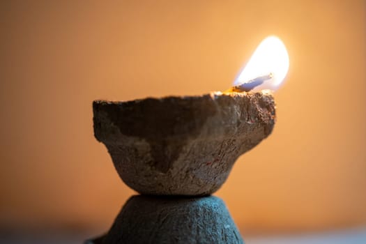 Organic diya lamp made of organic coconut fiber filled with oil and lit to provide light and as an offering to the hindu gods on the festival of diwali India