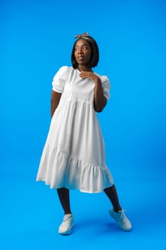 Full length portrait of a beautiful young african woman posing in photostudio close up