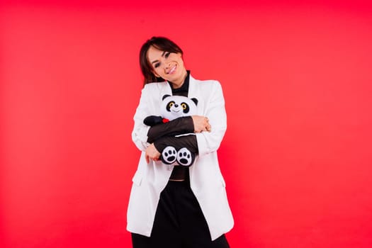 Portrait of cute woman posing in a studio with panda