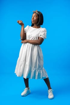 Full length portrait of a beautiful young african woman posing in photostudio close up