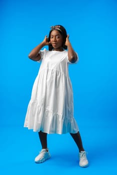 Full length portrait of a beautiful young african woman posing in photostudio close up