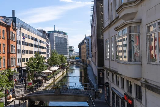Cityscape with passing people and buildings. Summer city Aarhus, Denmark -September 10, 2023.